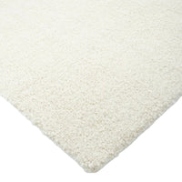 Close-up of a textured white rug corner on a white background