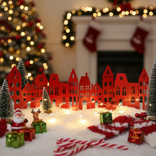 Christmas scene with red paper houses, Santa Claus, and Christmas trees in a cozy room.