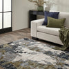 Living room with a patterned rug, beige sofa, and decorative pillows.