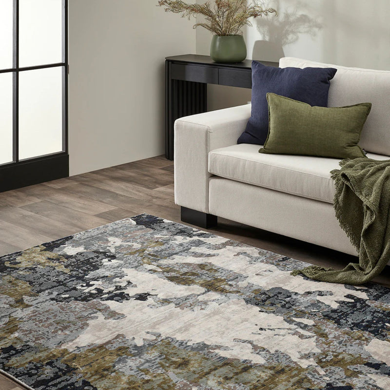 Living room with a patterned rug, beige sofa, and decorative pillows.
