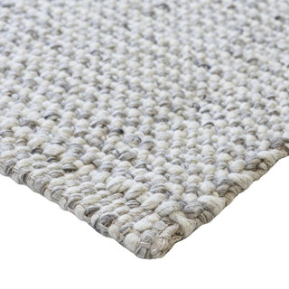 Close-up of a textured beige rug on a white background