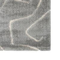 Close-up of a textured gray stone surface with white lines.