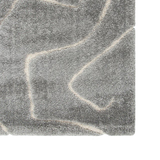 Close-up of a textured gray stone surface with white lines.