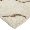 Close-up of a textured beige rug with brown accents