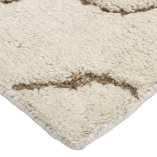 Close-up of a textured beige rug with brown accents