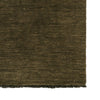 Close-up of a moss coloured textured rug corner
