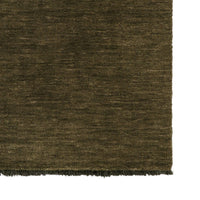 Close-up of a moss coloured textured rug corner
