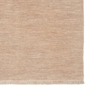 Beige woven rug with a textured pattern on a white background