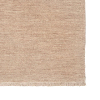 Beige woven rug with a textured pattern on a white background