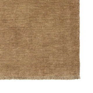 Close-up of a textured brown rug with a white background