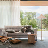 Modern living room with a gray sofa, wooden coffee table, and floor lamp.