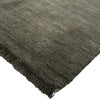 Dark gray rug with fringed edge on a white background