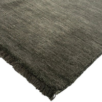 Dark gray rug with fringed edge on a white background
