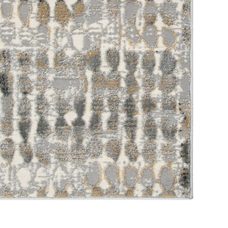 Patterned rug with geometric design in gray, beige, and white on a plain background