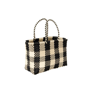 Black and white checkered woven basket on a white background