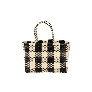 Black and white checkered woven handbag on a white background