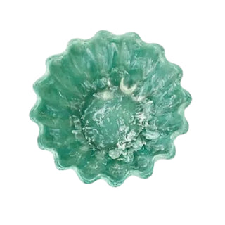 Green decorative item with floral design on a white background