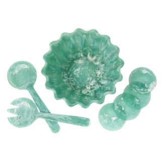 Set of green ceramic items including a bowl, spoon, and fork on a white background