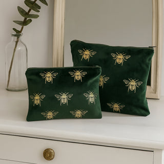 Velvet green toiletry bag on a dresser