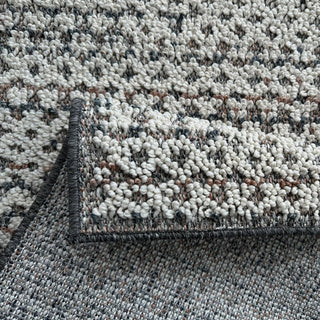Close-up of a textured area rug with a geometric pattern