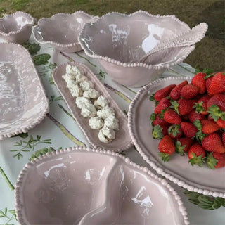 French Pink melamine pearl salad servers styled with matching serveware and fresh strawberries