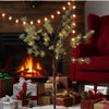 Decorative Christmas tree with lights in a festive living room with presents and a fireplace.