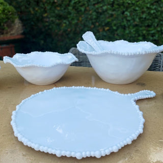 Outdoor table setting with white melamine pearl bowls and plates