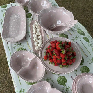 French Pink melamine pearl serveware collection on outdoor table with strawberries