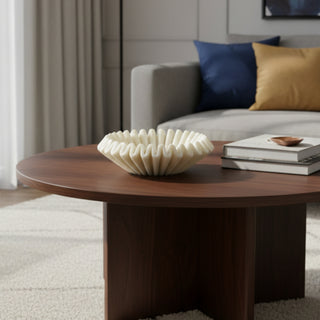Wooden coffee table with decorative bowl and books in a living room setting