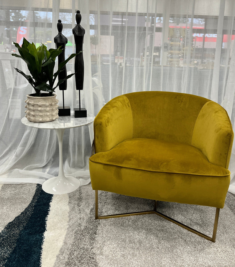 Chrighton Gold velvet occasional chair with gold metal legs.