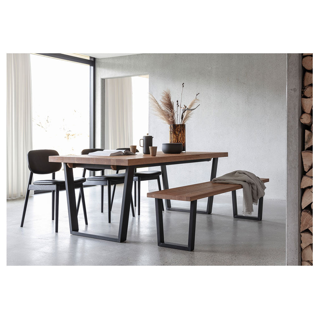 Calia dining table and bench seat in industrial setting